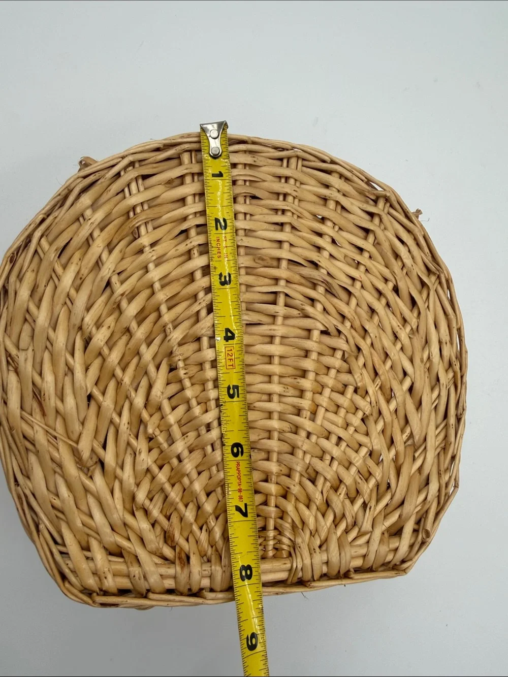 A Cute, charming vintage shell-shaped rattan storage basket with a front handle.